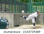 White pitches thrown by a pitcher taking pitching practice to warm up his shoulder in the bullpen during a baseball game.