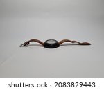 Black watch with brown strap on white background
