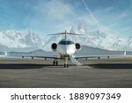 Private jet waiting to be boarded on runway with snowy mountains in the background