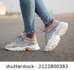 A man wearing sport sneakers on street . Men's sports shoes
