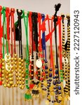 Small photo of Colorful handicraft necklaces and earrings displayed at a marketplace, various shapes and shades of necklaces , handicrafts on display during the Handicraft Fair in Pune, India.