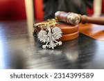 Small photo of 06.07.2023 wroclaw, poland, Polish court trial law insignia lies on the bench.