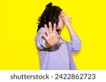 Small photo of Woman in distress making a stop hand gesture, symbolizing a plea against violence and for women's rights