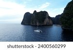 Small photo of Krabi, Thailand, 04, June, 2023: Phi Phi Ley Island in Krabi, flight along Phi Phi Island in the early morning, a sailing yacht stands at the entrance to Pile Bay