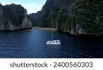 Small photo of Krabi, Thailand, 04, June, 2023: Phi Phi Ley Island in Krabi, flight along Phi Phi Island in the early morning, a sailing yacht stands at the entrance to Pile Bay