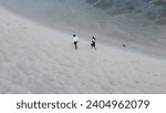 Small photo of Tourists walk along the famous spit at low tide, tourists on a popular spit with tourists at low tide, tourism in Thailand