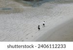 Small photo of Tourists walk along the famous spit at low tide, tourists on a popular spit with tourists at low tide, tourism in Thailand