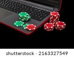 Small photo of Gambling online casino Internet betting concept. Jackpot, casino chips. computer keyboard, laptop with poker chips, dice. Casino tokens, gaming chips, checks, or cheques.