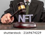 Judge and NFT non-fungible token concept. Judge's gavel on the table. Law Lord wearing gown using a hammer for verdict. Legalization of Internet trade in virtual goods and art.