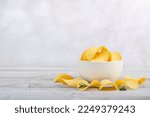 Potatoes Chips. Chips in white bowl good for snack for beer on wooden table. Good for beer festival, pub, restaurant advertising. Copy space for text or logos.