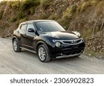 Small photo of Swat, Pakistan - May 19 2023: Nissan impul black subcompact crossover SUV Japanese car