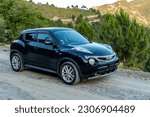 Small photo of Swat, Pakistan - May 19 2023: Nissan Juke Impul black japanese in a countryside of Pakistan mountain area