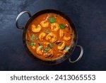 Traditional spicy Indian prawn Madras curry Rogan Josh with king prawns served as top view in a korei bowl with copy space 