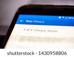 Small photo of Stop a cheque button on smartphone app screen closeup