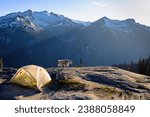 A Mountain Goat Passes Tent Camp With Mt Daniel Visible Beyond. 
Alpine Lakes Wilderness. Cascade mountains, Washington