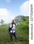 Asian Young Girl Is Trekking On ...