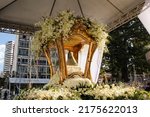Small photo of Belem, Para, Brazil, July 2022. The litter decorated with white flowers, with the image of Our Lady of Nazareth inside a glass dome. Procession of the Cirio de Nazare.