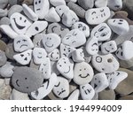 Small photo of Emotion management concept, stones with painted faces symbolize different emotions. We are all different, but all together, learning to manage emotions. Emotional intelligence, role model. Good mood.