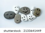 Small photo of Tolerance and solidarity. Painted faces on different stones as a symbol of teamwork. International tolerance and emotional intelligence. Joint action and existence. One team called humanity.
