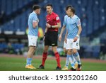 Small photo of ROME, Italy - 12.03.2021: Patric (LAZIO), REFEREE RAPUANO, Lucas Leiva (LAZIO) in action during the Italian Serie A league 2021 soccer match between SS LAZIO VS CROTONE at Olympic stadium in Rome.