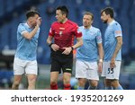 Small photo of ROME, Italy - 12.03.2021: Patric (LAZIO), REFEREE RAPUANO, Lucas Leiva (LAZIO) in action during the Italian Serie A league 2021 soccer match between SS LAZIO VS CROTONE at Olympic stadium in Rome.