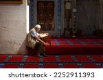 Small photo of Islamic photo. Muslim man reading the Holy Quran in the mosque. Religious person. Ramadan or kandil or laylat al-qadr or islamic concept photo. Istanbul Turkiye - 9.9.2022