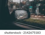 Side mirror car in rainy day, water drop on window