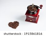 A Dark Red Coffee Grinder And...