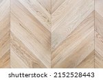 Small photo of Top view of an french herringbone parquet floor under natural light. Wooden pattern with oak diagonal texture.