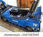 Small photo of Callicoon, NY, USA, 10.11.22 - Go Karts that are parked in separate lanes. A blue gokart says the number 10 and brand Kleenex on it.