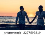 Photoshoot of young helthy beautiful caucasian couple, boy and girl, dating at the beach - Man and woman lovers having fun in holidays walking near the ocean in a sunny day