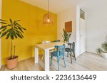 A dining room with yellow walls ...