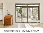 Small photo of a living room with sliding glass doors that open up to the patio and backyard area in the house is white
