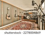 Small photo of Amsterdam, Netherlands - 10 April, 2021: a music room with guitars on the wall and an electric guitar in the fore - hand position next to it