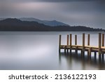 A Wooden Pier Next To A Body Of ...