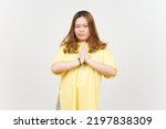 Begging to say sorry of Beautiful Asian Woman wearing yellow T-Shirt Isolated On White Background