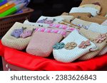 Small photo of PHETCHABUN, THAILAND – OCTOBER 15, 2022: A woven bag by handmade for sold near the main road at Khao Kho district in Phetchabun province of Thailand.
