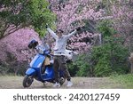 Small photo of NAN, THAILAND – JANUARY 17, 2024: Asian man standing with motorcycle on the high mountain in the morning at Khunsathan Watershed Research Station in Nan province of Thailand.Road trip by motorcycle.