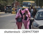 Small photo of impact of climate change - people trying to save yourself from scorching hot summer in the month of April. Gurgaon, India. April 15, 2023.