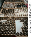 Small photo of Terengganu. February 21, 2024. Various flavors of baby donuts sold during the Food Mania Festival. Arranged nicely on the surface of the table.
