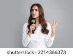 Small photo of Beautiful business woman is speaking on conference. Young business woman talking with mic. Woman talking with microphone. Communication and information concept.