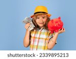 Kid saving money in a piggy bank, learning about saving, Kid save money in piggybank. Business, saving and economic.