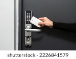 Concepts of self check-in with modern security system. Cropped shot of woman using plastic card to opened the door in hotel room. Keyless lock, wireless technology and temporary codes for entrance