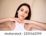 Small photo of brunette woman with healthy radiant skin and natural makeup posing on camera. eyebrow lamination procedure, skincare treatment. advertising concepts of cosmetology, dermatology and aesthetic medicine