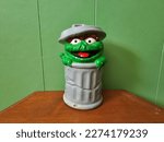 Small photo of Liverpool, NS, CAN, March 5, 2023 - A closeup of an Oscar the Grouch piggy bank sitting on a shelf.