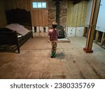 Small photo of Queens County, NS, CAN, October 21, 2023 - A child creating a slingshot in a downstairs basement.