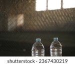 Small photo of two bottles of drinks were photographed against the background of the futsal game area. the concept of adequate hydration during exercise