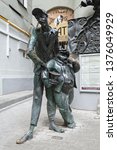 Small photo of MOSCOW, RUSSIA - June 6, 2018: Statue of Behemoth (black cat) and Fagotto (Korovyev) at the entrance of Mikhail Bulgakov Museum in Moscow