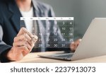 Small photo of Businessman manages time for effective work. Calendar on the virtual screen interface. Highlight appointment reminders and meeting agenda on the calendar. Time management concept.