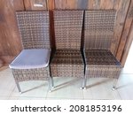 Three Brown Wooden Chairs That...